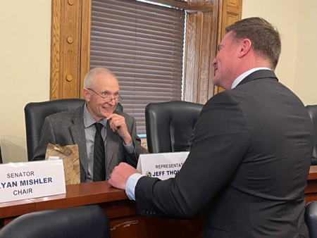 Rep. Jeff Thompson (left, R-Lizton), the chair of the House Ways and Means Committee, talks to Sen. Chris Garten  (R-Charlestown) before a budget meeting. (Whitney Downard/Indiana Capital Chronicle)