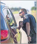 Franklin police officer Alex Eckert speaks to a motorist during a traffic stop on U.S. 31 in July 2020. Daily Journal File Photo