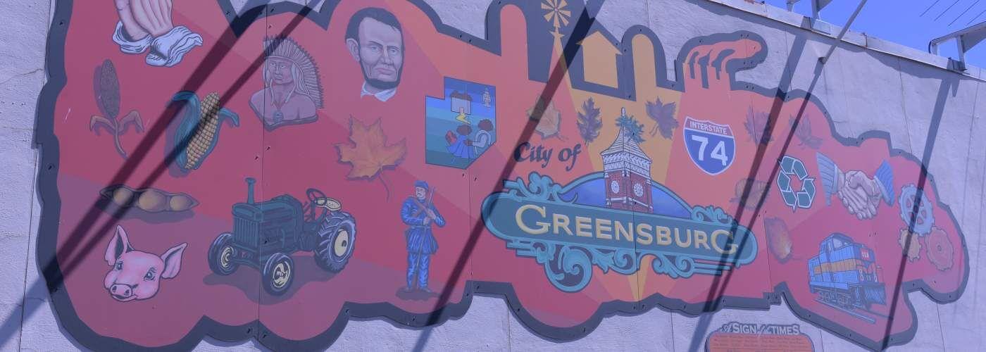 A downtown mural in Greensburg touts the community’s history and economy. Greensburg is offering $5,500 and other perks to remote workers who move there.  Photo provided by City of Greensburg