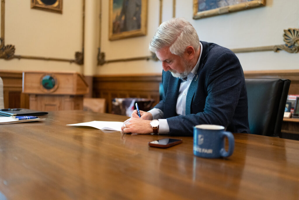Gov. Eric Holcomb signs dozens of new bills into law on Thursday, May 4, 2023. (Photo from Gov. Eric Holcomb’s Flickr)