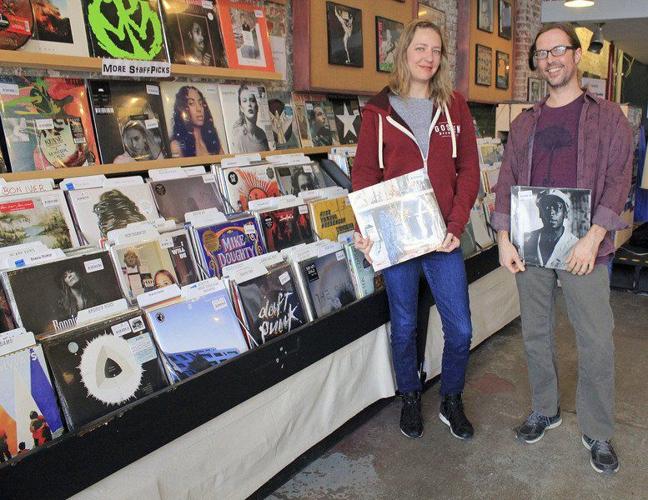 Julie Herschberger and Tim Hachstetler, owners of Ignition Music Garage in Goshen, stand near a display of vinyl records. Staff file photo