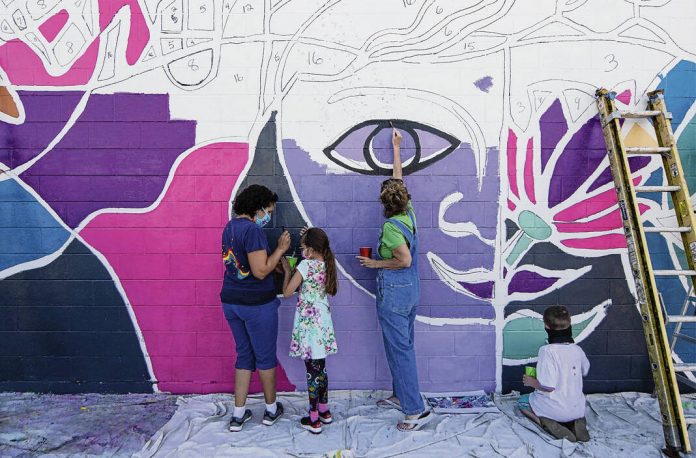 Volunteers paint a Color the County mural in Bargersville during the community painting day in 2020.  DAILY JOURNAL FILE PHOTO