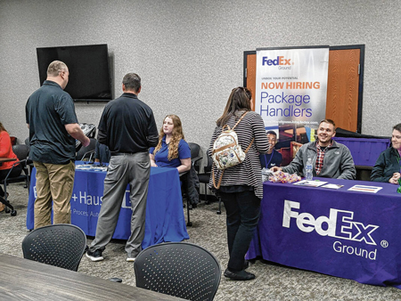 Representatives from FedEx and Endress+Hauser take part in a job fair for students with disabilities as part of Aspire Johnson County’s school-to-work program. Submitted photo