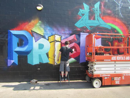 An artist paints a mural at Merge Walls Festival last week in Hammond. Staff photo by Joseph S. Pete