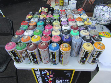 Spray cans are stacked up at the Merge Walls Festival Art Festival in Hammond. Staff photo ny Joseph S. Pete