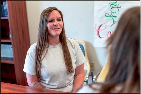Newly credentialed peer recovery coach Sarah Jaskowiak speaks with a recovering addict on Friday at the Rockville Correctional Facility. Indiana Department of Correction photo