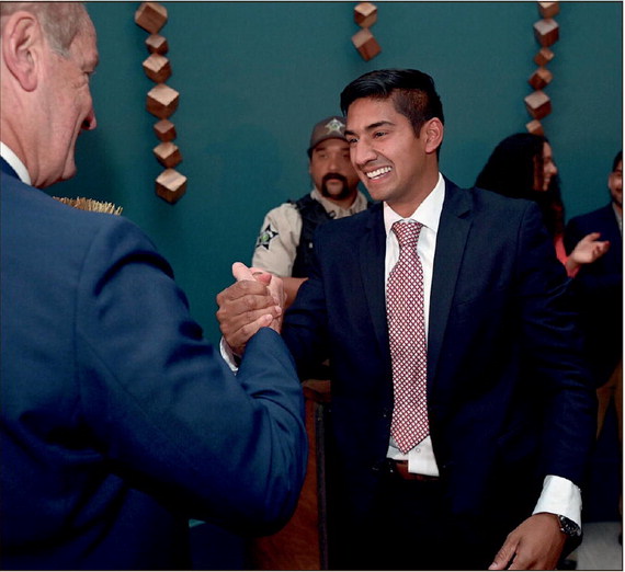 Terre Haute mayor-elect Brandon Sakbun, right, is congratulated by Vigo County Democratic Party Chair Joe Etling after Sakbun saw the final vote totals on Tuesday at the Hilton Garden Inn in downtown Terre Haute. 
Tribune-Star/Joseph C. Garza