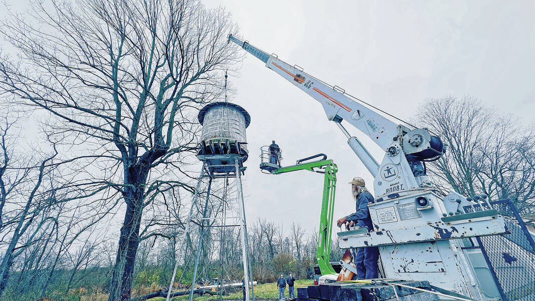 Pioneer Engineers Club of Rushville spent hours carefully deconstructing the water tower along west U.S. 40 in Greenfield before loading it into a flatbed trailer and hauling it to the club’s property — Caldwell Pioneer Acres — a living history museum in Rushville. Staff photo by Tom Russo