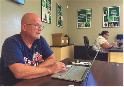 Rob Pryor, programs manager at the Homeless Coalition of Southern Indiana, and Latravia Benson, program manager at Jeffersonville Housing Authority, were among those ready in this 2021 photo to help residents with applications for rental assistance and other services. News and Tribune file photo
