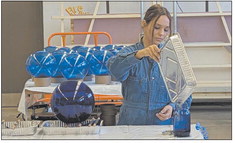 Brenna McCarty works on her art project, Blue Skies, now installed at the Indianapolis International Airport. Submitted photo