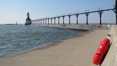 The length of the lighhouse pier in Michigan City is equipped with life rings sinside hard plastic caves spaced about 100 yards apart. Indiana lawmakers gave final approval Thursday to legislation requiring all municipalities adjacent to Lake Michigan install them and other rescue equipment at each pier and public access point in the lake no  later than July 1, 2024. Photo by Stan Maddux