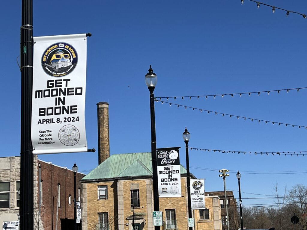 Signs advertising eclipse-themed events line the street in Lebanon, Indiana, in March 2024. (Niki Kelly/Indiana Capital Chronicle)