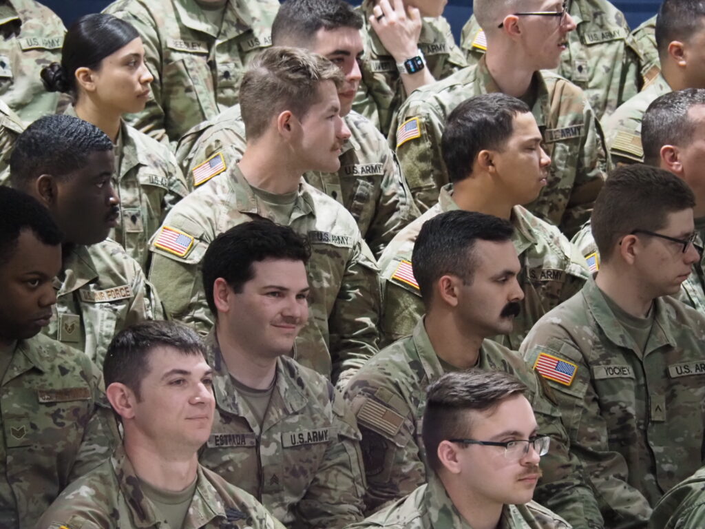 Indiana National Guard members listen as Gov. Eric Holcomb speaks at a departure ceremony on Thursday, March 28, 2024. Soldiers soon leave for Texas. (Leslie Bonilla Muñiz/Indiana Capital Chronicle)