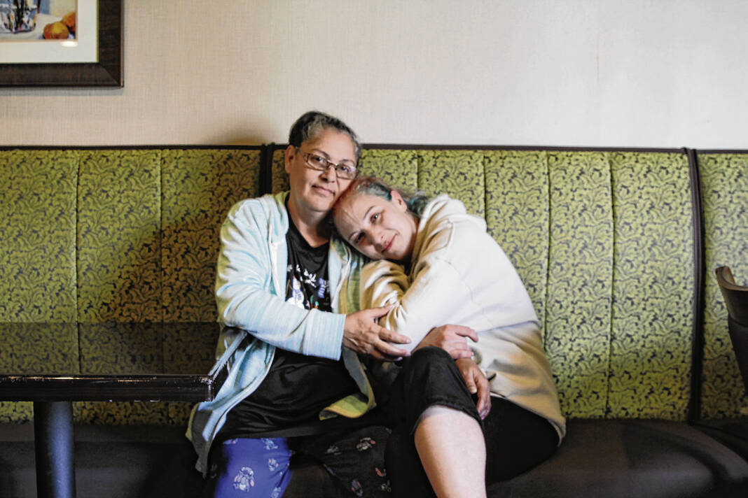 Sabrina Hamilton and her daughter Ashly pose for a photo Tuesday at the Quality Inn in Franklin. Hamilton has been living in the hotel for nearly two years after a car crash left her with serious injuries, and is now looking for a place to stay for eclipse weekend. Jayden Kennett | Daily Journal