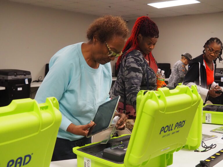 Marion County poll inspectors set up electronic poll-books during training on Thursday, April 19, 2024. (Leslie Bonilla Muñiz/Indiana Capital Chronicle)
