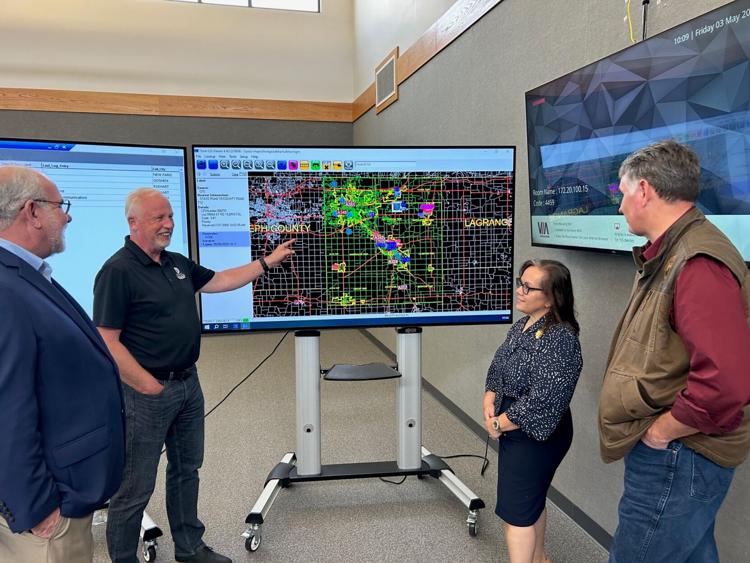 State Treasurer and Board Chair of 911 Operations Daniel Elliott, Indiana State Rep. District 49 Joanna King (both right) and Executive Director of the Statewide 911 Board Jeff Schemmer, far left, speak with Elkhart County 911 Director Egbert Dijkstra at the Elkhart County 911 Call Center Friday. Dani Messick | The Goshen News