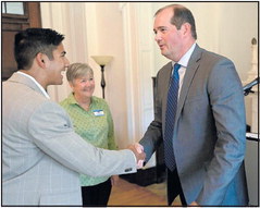 New Saint Mary-of-the-Woods College President Brennan Randolph, right, shakes hands with Mayor Brandon Sakbun after the press conference to announce that he has been named the 17th president of the college on Friday in SMWC’s Le Fer Hall. Tribune-Star/Joseph C. Garza