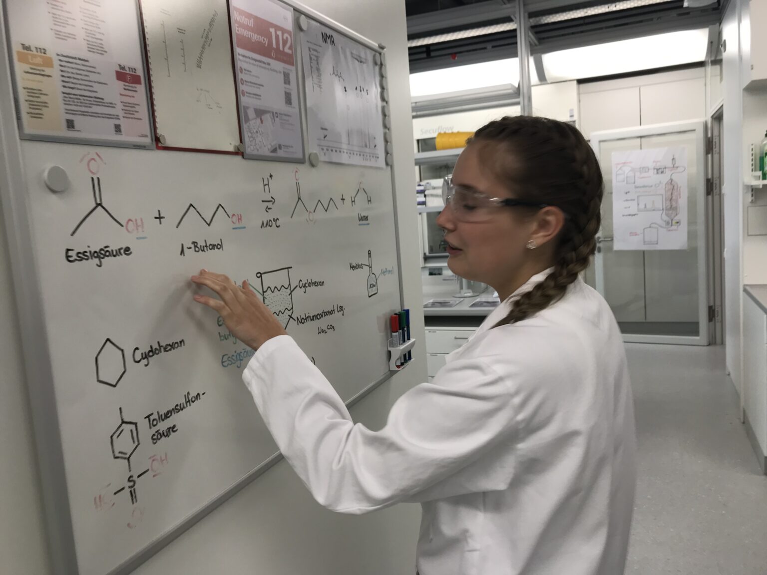 An apprentice of the Roche pharmaceutical company explains some of the work she and other apprentices do at the company’s training center outside Basel, Switzerland in 2022. Teams from Indiana have been working with Swiss experts to adapt the Swiss apprenticeship system to that state. (Photo by Patrick O’Donnell/The 74)