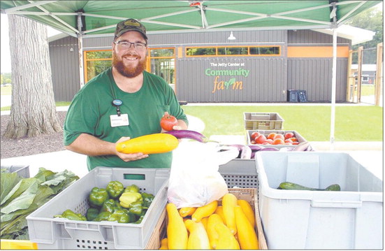 Mikkal Hodge, farm project coordinator for Community Hospital Anderson, shows off some of the produce grown through the Community Farm as part of a farm stand program, which will have its last distribution of the season on Aug. 28. Submitted photo