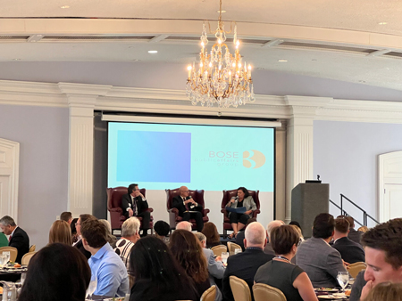 Philip Powell, executive director of the Indiana Business Research Center (left), and urban policy and culture researcher Aaron Renn,, (center) discuss the Hoosier economy at the Indiana Fiscal Policy Institute’s annual luncheon on Wednesday, Sept. 18, 2024, in Indianapolis. Courtney Arango, director of government affairs for AES Indiana, served as the moderator. (Casey Smith/Indiana Capital Chronicle)