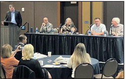 Terre Haute Chamber of Commerce Director of Community Engagement Josh Alsip, standing at left, moderates Thursday’s panel on tourism featuring, left to right, Capital Improvement Board President Chris Switzer, Terre Haute Children’s Museum Executive Director Susan Turner, Charlie’s Pub and Grub owner Cheyne O’Laughlin and Tim Dora, Dora Hotel Company president. David Kronke/Tribune-Star

