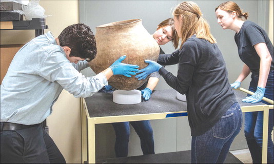 Museum studies graduate students from Indiana University-Purdue University Indianapolis (IUPUI) help care for the recovered artifacts in a facility near Indianapolis where all the recovered artifacts were housed securely and temperature, humidity, and light levels were controlled. Students and highly trained IUPUI staff also helped prepare the artifacts for shipping for repatriation. Photo provided