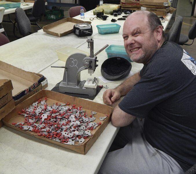 Zechariah Reichman enjoys having a job and working for a paycheck as a client in the day program at DSI. Bill Rethlake | CNHI News Indiana