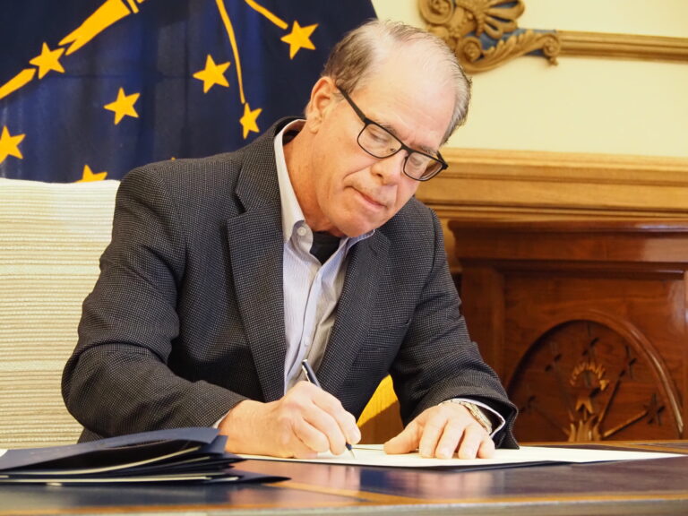 Republican Gov. Mike Braun signs a slew of new executive orders on Wednesday, Jan. 15, 2025., at the Indiana Statehouse (Whitney Downard/Indiana Capital Chronicle)