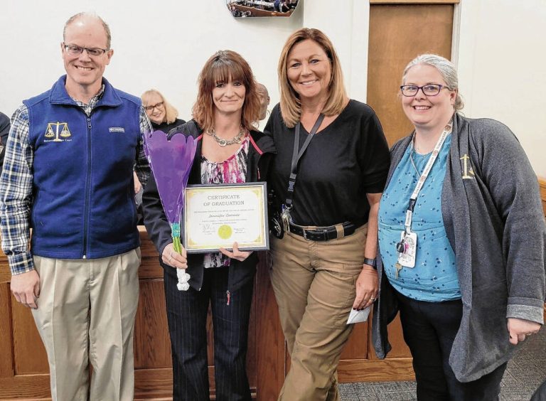 From left, Hancock County Superior Court 1 Judge D.J. Davis, participant Jennifer Coomer, program field officer Tracy Shaw and Behavioral Health Court Coordinator Karey Hall celebrate the first graduate from the program earlier this month.