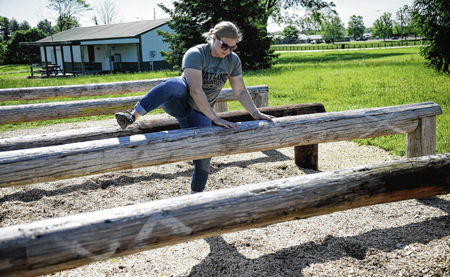 Shelby Morse, marketing director for Festival Country Indiana, demonstrates the Over and Under station at the Gatling Gauntlet at the Johnson County Park in June 2022. Daily Journal File Photo