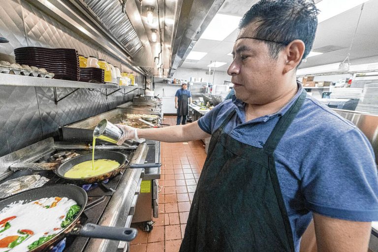 A cook at Lincoln Square Pancake House in Greenfield prepares an omelette. Egg prices are still on the rise and are impacting business owners as well as consumers.