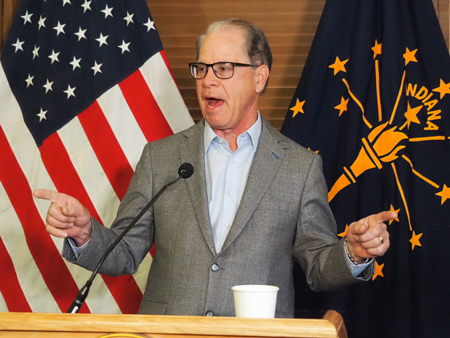 Gov. Mike Braun talks to reporters during a news conference halfway through the legislative session on Tuesday, Feb. 25, 2025. (Leslie Bonilla Muñiz/Indiana Capital Chronicle)
