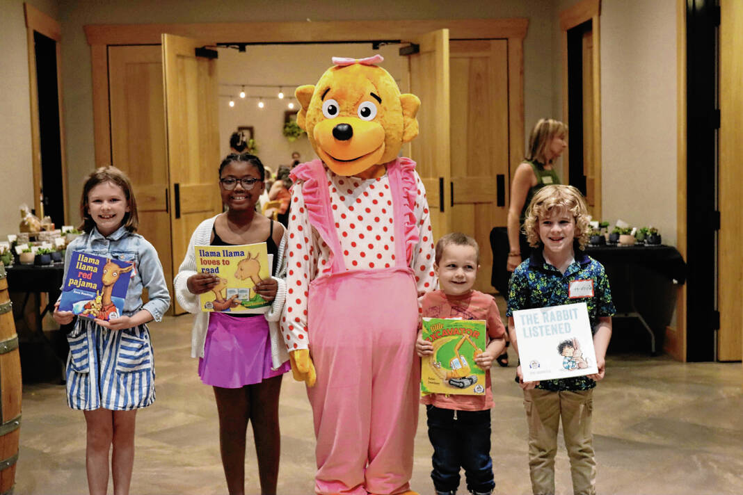 From left, Mari Alexander, Jorgia Yarnell, Kase Backscheider and Harrison Martin pose with Sister Bear from The Berenstain Bears series of books during Imagination Library of Johnson County’s Appreciation and Awareness event on April 29. After Indiana legislators cut matching funding for the early literacy program from the state budget, local leaders are unsure how the move impacts the Imagination Library. SUBMITTED PHOTO BY STACIE DRANE