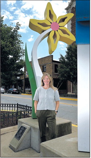 As the new executive director of Art Spaces, Ellie Templeton hopes to draw more attention to the city’s sculptures like C.J. Rench’s Urban Flowers which she stands by here on Wednesday on South Seventh Street. Staff photo by Joseph C. Garza