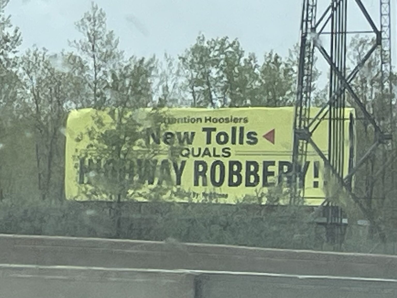 A billboard opposing possible additional tolling stands in Hobart, Indiana, on May 4, 2025. (Leslie Bonilla Muñiz/Indiana Capital Chronicle)