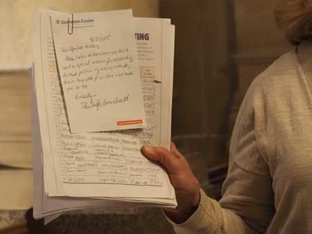  Common Cause Indiana Executive Director Julia Vaughn holds up a stack of 4,139 signatures, collected from opponents of mid-cycle redistricting, before delivering them to office staff of Indiana’s Republican legislative caucuses on Wednesday, Aug. 27, 2025. (Leslie Bonilla Muñiz/Indiana Capital Chronicle)