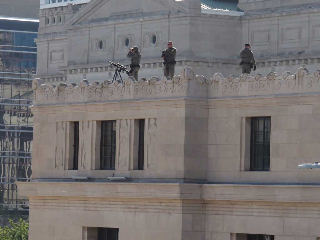 Three snipers position on the top of a downtown building during Vice President JD Vance’s Oct. 10, 2025 visit in Indianapolis. (Niki Kelly/Indiana Capital Chronicle)