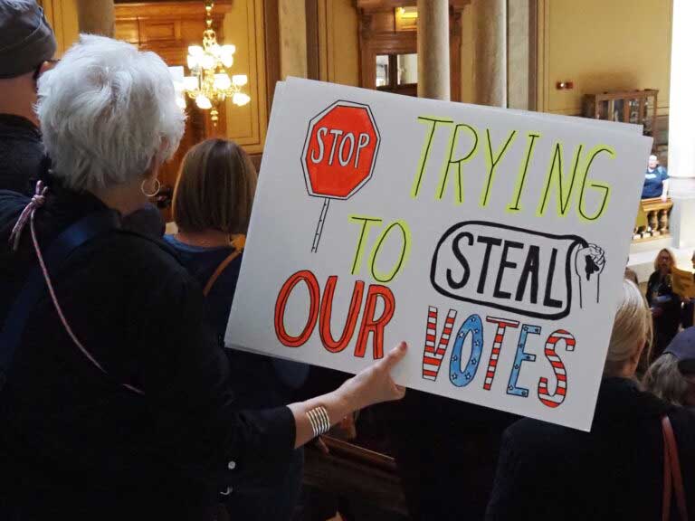 Hoosiers protest mid-cycle redistricting while at the Indiana Statehouse on Friday, Oct. 10, 2025. (Photo by Leslie Bonilla Muñiz/Indiana Capital Chronicle)