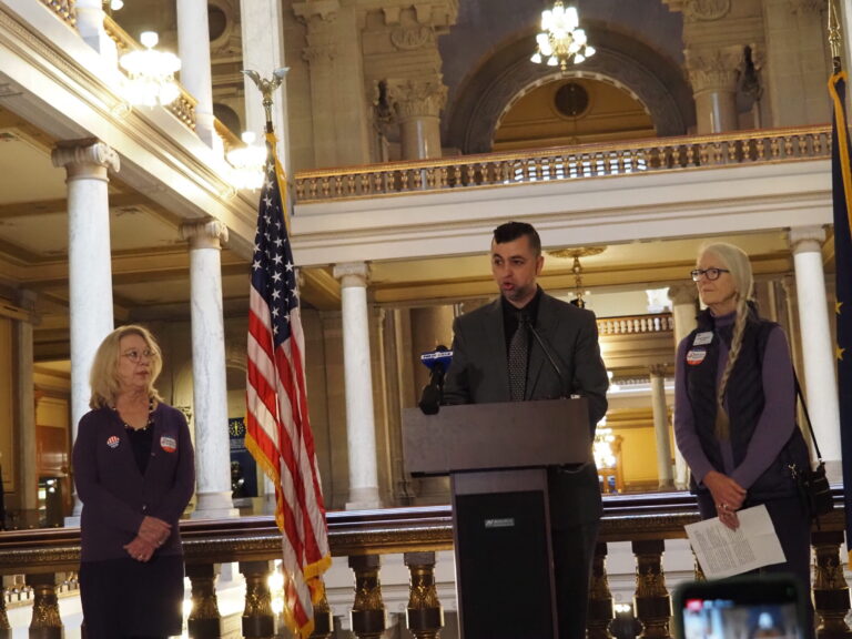 From left: Common Cause Indiana Executive Director Julia Vaughn, Indiana Sen. Fady Qaddoura, and League of Women Voters Indiana President Linda Hanson speak at a news conference about Qaddoura’s proposed mid-census redistricting ban on Monday, Dec. 1, 2025. (Leslie Bonilla Muñiz/Indiana Capital Chronicle)