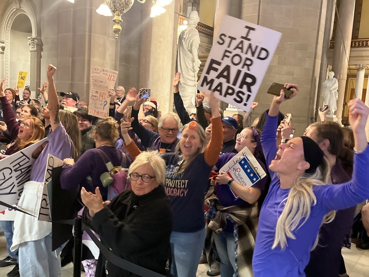 Protesters celebrate outside the Senate chamber when a redistricting bill is defeated on Dec. 11, 2025. (Photo by Tom Davies/Indiana Capital Chronicle)
