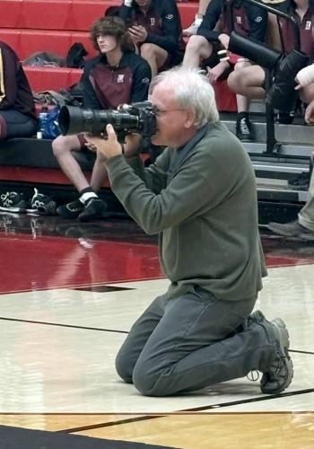 Photographer Richard Sitler taking photographs at a Knightstown High School wrestling match. Photo by Kevin Richey