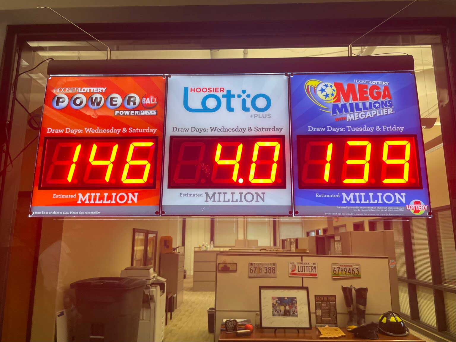 Hoosier Lottery signs hang in the organization’s downtown headquarters on Tuesday, May 20, 2025. (Leslie Bonilla Muñiz/Indiana Capital Chronicle)