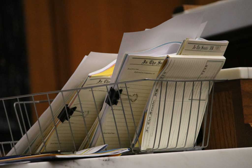 A basket of bills sit next to the Speaker's podium in the Indiana House of Representatives. (IBJ Photo/Cate Charron)