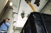 LaPorte County Co-Op employee Roger Ailes pulls a lever Tuesday that unloads corn into a truck. A debate centering on the use of ethanol, which is often made from corn, in gasoline is brewing among federal lawmakers. A House energy bill passed last month requires refineries to mix 5 billion gallons of renewable fuels, like ethanol, into gasoline annually. But some lawmakers, like Sen. Dick Lugar, R-Ind., want an even higher standard. Caey Riffe/Times of Northwest Indiana photo