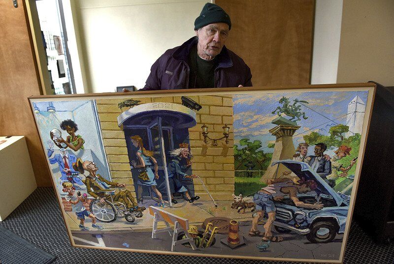 “Paint in the New Year” arrives: Mike Neary carries his “Crow Show” entry, “Paint in the New Year,” into the Arts Illiana gallery on Wednesday, Jan. 19, 2022. Tribune-Star/Joseph C. Garza