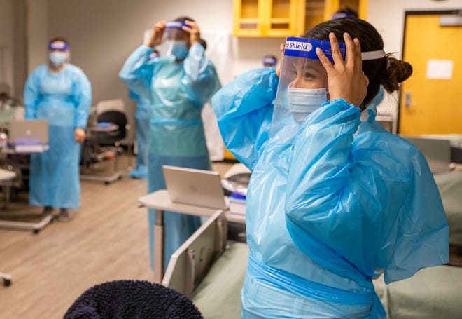 Ivy Tech nursing student Tania Lopez practices wearing PPE during class on Wednesday, Jan. 2022 at Ivy Tech Community College in South Bend. Staff photo by Robert Franklin