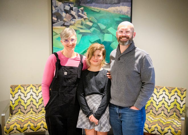 Kirin Clawson poses with her parents, Beth Clawson, left, and Nathaniel Clawson, right, in their home Wednesday, Feb 2, 2022 in Bloomington. Staff photo by Rich Janzaruk